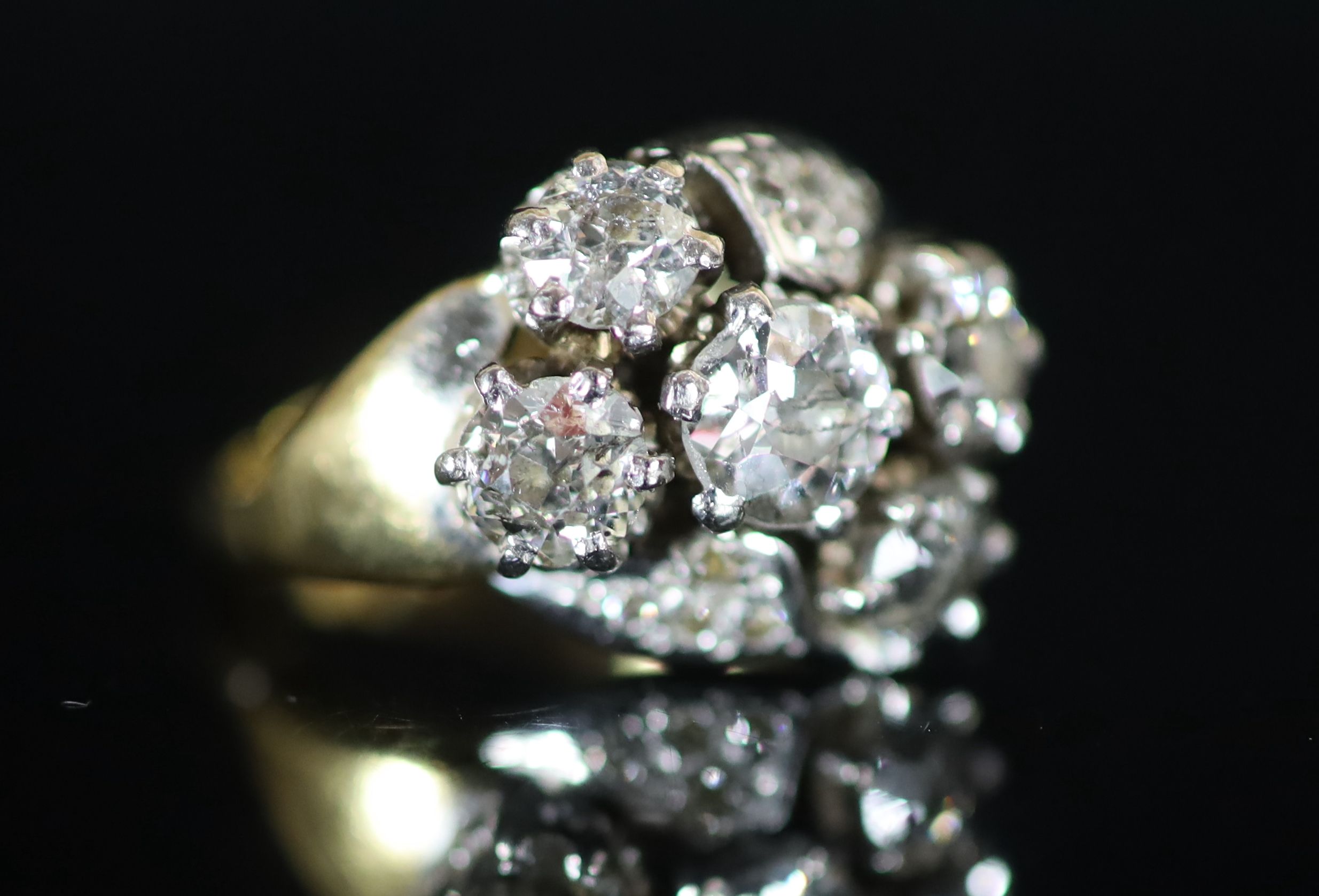 A mid 20th century 18ct gold and five stone diamond cluster ring